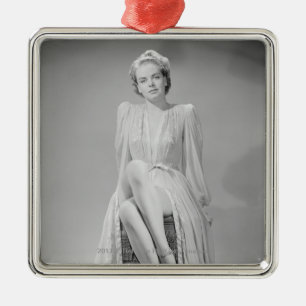 Studio portrait of young woman in nightgown metal tree decoration