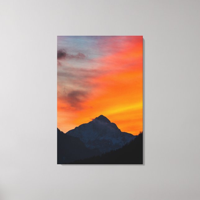 Stunning vibrant sunset behind mountain canvas print (Front)