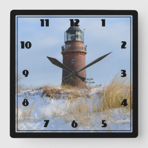 Sturdy Lighthouse on a Rocky Coast in Winter Square Wall Clock