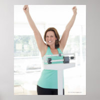 Successful weight loss. Happy woman weighing