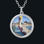Sun Day Ocean Beach Pier Pelican Bird Photo Cute Silver Plated Necklace<br><div class="desc">“Sun day.” This cute, happy pelican perched on a railing overlooking a California beach screams “vacation ready”. Drift back to the warm ocean breezes whenever you wear this colourful photography charm necklace. This necklace comes in small, medium and large sizes, as well as both square and circle shapes. You can...</div>