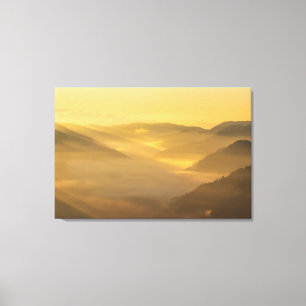Sun light shining on morning fog canvas print