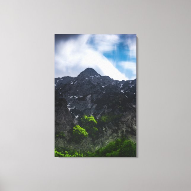 Sun lit green forest beneath the mountains canvas print (Front)