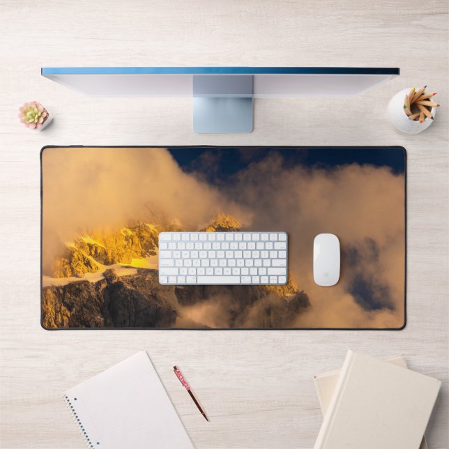 Sun lit mountains covered by clouds desk mat (Office 1)