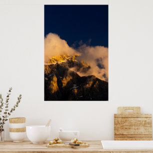 Sun lit mountains covered by clouds poster