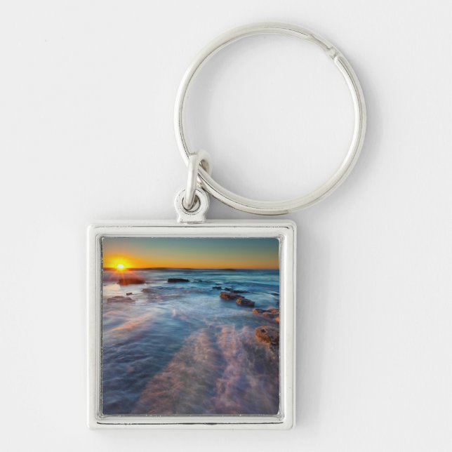 Sun rays illuminate the Pacific Ocean Key Ring (Front)