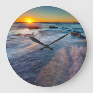 Sun rays illuminate the Pacific Ocean Large Clock