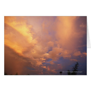 Sun setting behind clouds