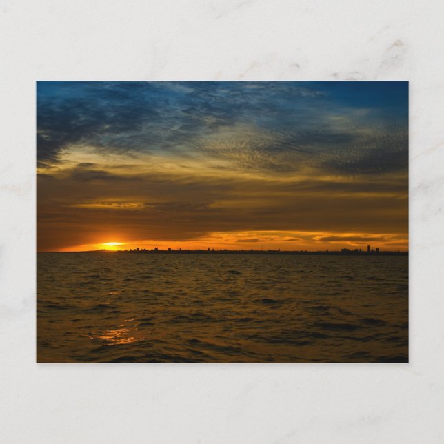 Sun setting down behind the city postcard (Front)