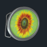 Sunflower Bold Floral Yellow and Green Flower Oval Belt Buckle<br><div class="desc">This cute summer floral design has a bold sunflower blossom in full bloom. It's made in shades of bright yellow, vivid orange and brown and green on a slightly distressed / grunge summery green background. The big flower has a painted look. If you love gardens and flowery motifs, you'll love...</div>