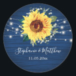 Sunflower Navy Babys Breath Lights Wedding Classic Round Sticker<br><div class="desc">These wedding stickers feature a rustic sunflower, babys breath flowers and string lights on a navy blue wood grain background. Personalise these stickers with your names and wedding date. These stickers are part of a collection which includes matching wedding stationery and gifts. Please visit the collection pages in our store...</div>
