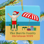 Sunny Beach Santa Claus Cute Custom Christmas Ceramic Ornament<br><div class="desc">This cute custom Christmas in July ornament makes perfect summer party decor for a beach bash or pool gathering. Make it a fun north pole themed extravaganza with Santa Claus in his swimming trunks next to a red and white striped beach umbrella and gifts. I've never seen Mr. Klaus in...</div>