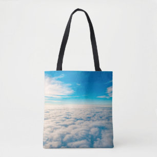 Sunrise above clouds from aeroplane window tote bag