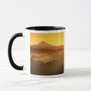 Sunrise orange colours the fog in the valley in mug