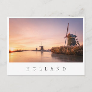 Sunrise over frozen river with windmills and reeds postcard