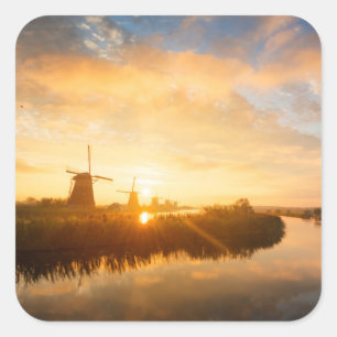 Sunrise over windmills and a river in Holland Square Sticker
