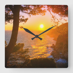 Sunset at the coast square wall clock