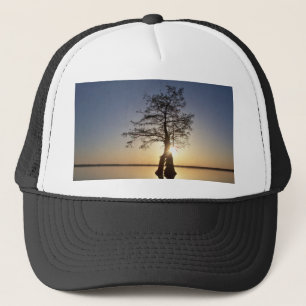 Sunset Behind a Tree Trucker Hat