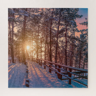 Sunset in snowy pine forest with sun ray jigsaw puzzle