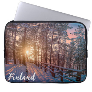 Sunset in snowy pine forest with sun ray laptop sleeve