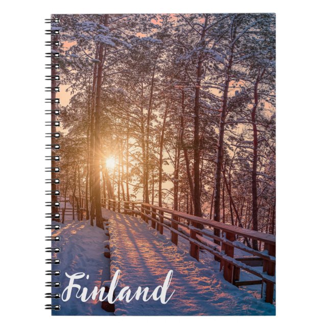 Sunset in snowy pine forest with sun ray notebook (Front)
