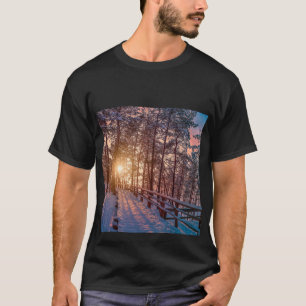 Sunset in snowy pine forest with sun ray T-Shirt