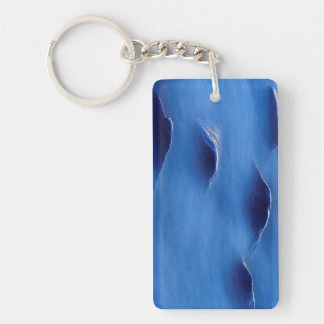 Sunset on rocks protruding through foamy water key ring (Front)