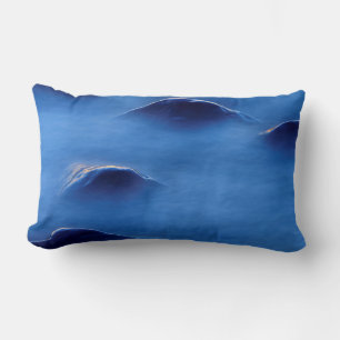 Sunset on rocks protruding through foamy water lumbar cushion