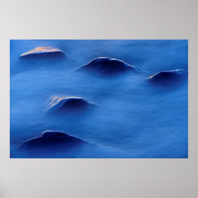 Sunset on rocks protruding through foamy water poster (Front)