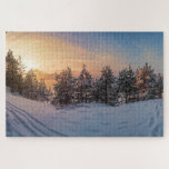Sunset over frozen snowy forest near sea jigsaw puzzle<br><div class="desc">View of frozen snowy forest with covered in snow spruce,  fir and pine trees on sea coast.</div>