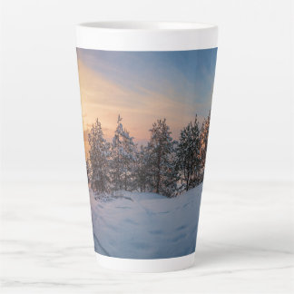 Sunset over frozen snowy forest near sea latte mug