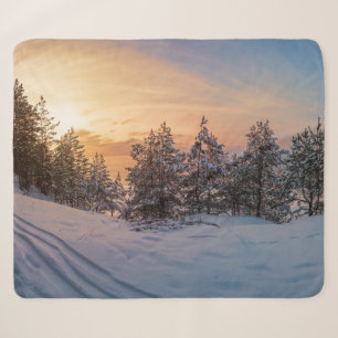 Sunset over frozen snowy forest near sea sherpa blanket
