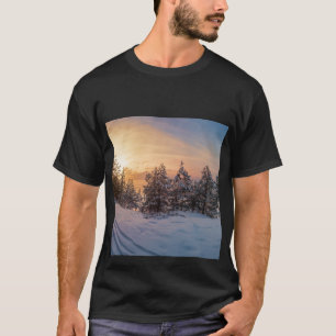 Sunset over frozen snowy forest near sea T-Shirt