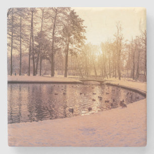 Sunset over park with small frosty lake stone coaster