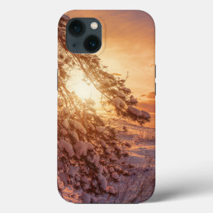 Sunset over sea and snowy pine tree iPhone 13 case