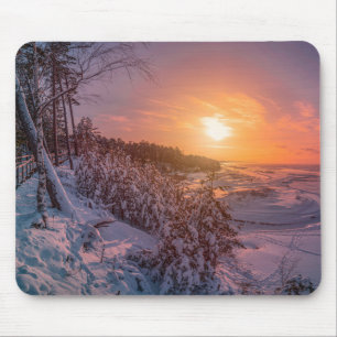 Sunset over snow sea coast mouse pad