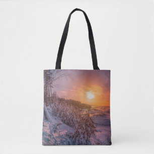 Sunset over snow sea coast tote bag
