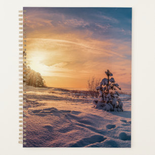 Sunset over snowy winter sea coast planner
