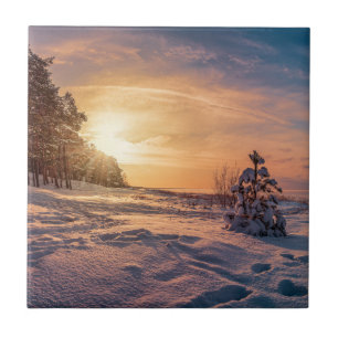 Sunset over snowy winter sea coast tile