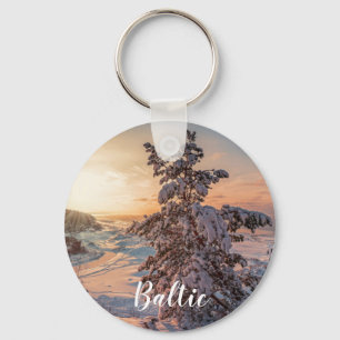 Sunset over winter snowy sea coast key ring