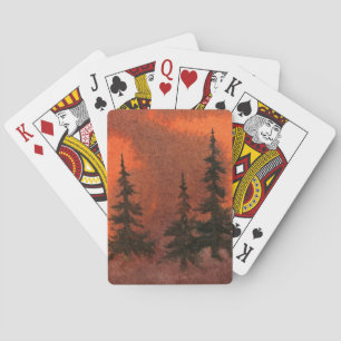 Sunset pines in the orange and violet evening mist playing cards