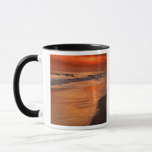 Sunset reflections off clouds and ocean shore mug