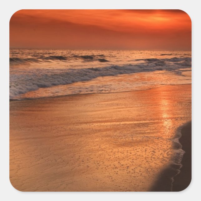 Sunset reflections off clouds and ocean shore square sticker (Front)