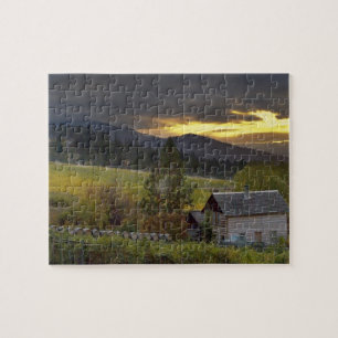 Sunset sky over vineyards and historic log cabin jigsaw puzzle