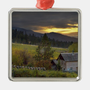Sunset sky over vineyards and historic log cabin metal tree decoration