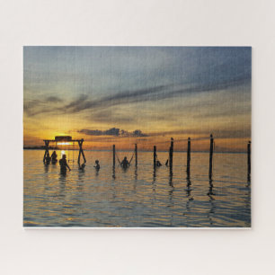 Sunset with Wooden Posts in Water Jigsaw Puzzle