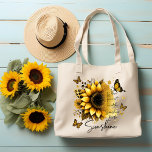 Sunshine Be the Sunshine Sunflower | Tote Bag<br><div class="desc">This tote bag features a clean, modern design with a soft, uplifting aesthetic. The bag itself is white with sturdy black shoulder straps, creating a nice contrast that makes the artwork stand out. The front showcases a large, beautifully detailed sunflower in rich golden and amber tones, with layered petals and...</div>