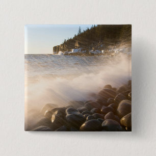 Surf washes over the cobblestones in Monument 15 Cm Square Badge