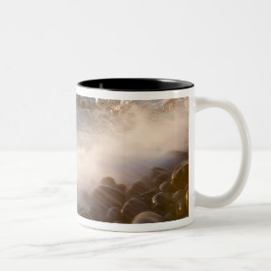 Surf washes over the cobblestones in Monument Two-Tone Coffee Mug