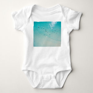 Surfers aerial view, clear ocean. baby bodysuit
